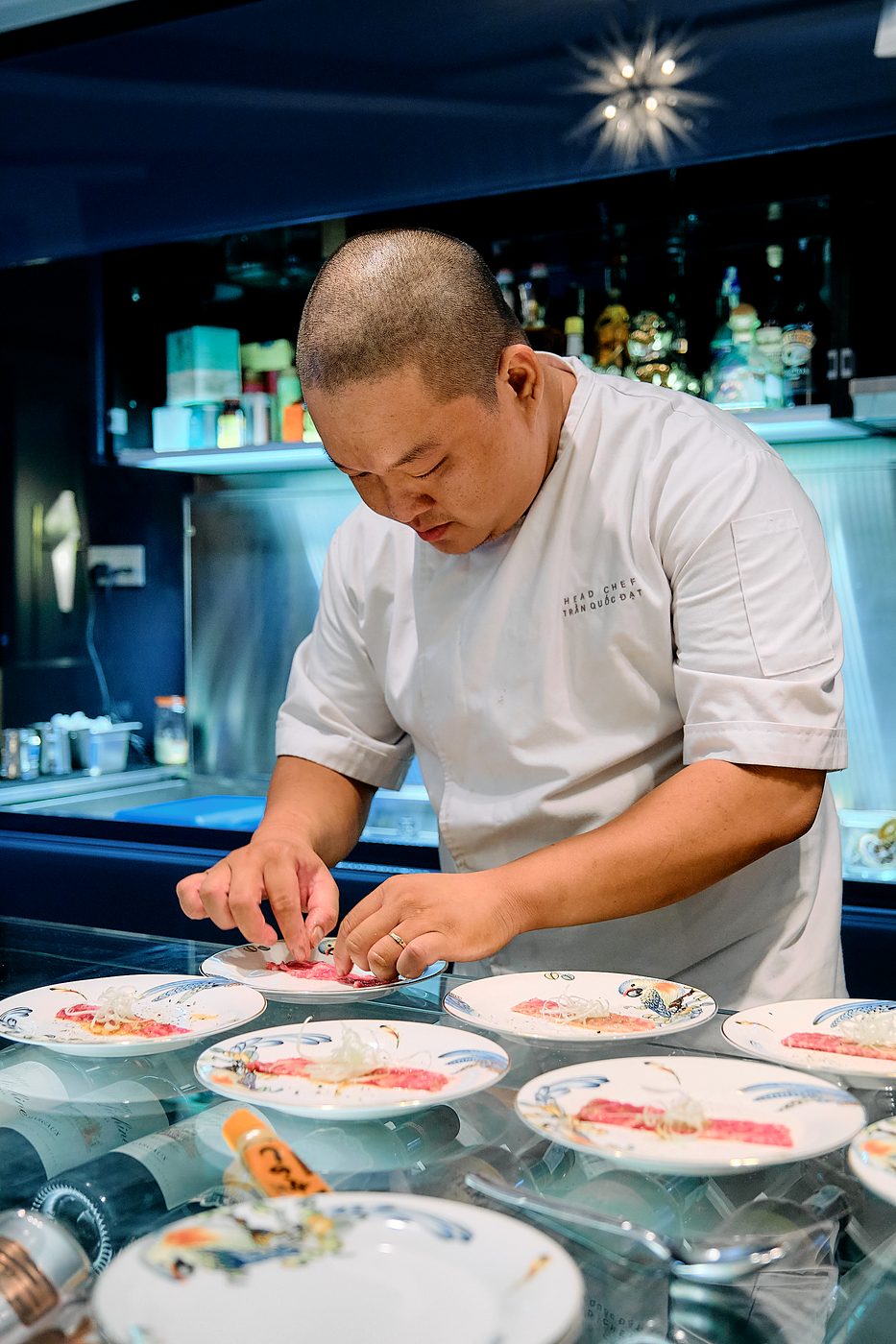 Chef Trần Quốc Đạt plating a course